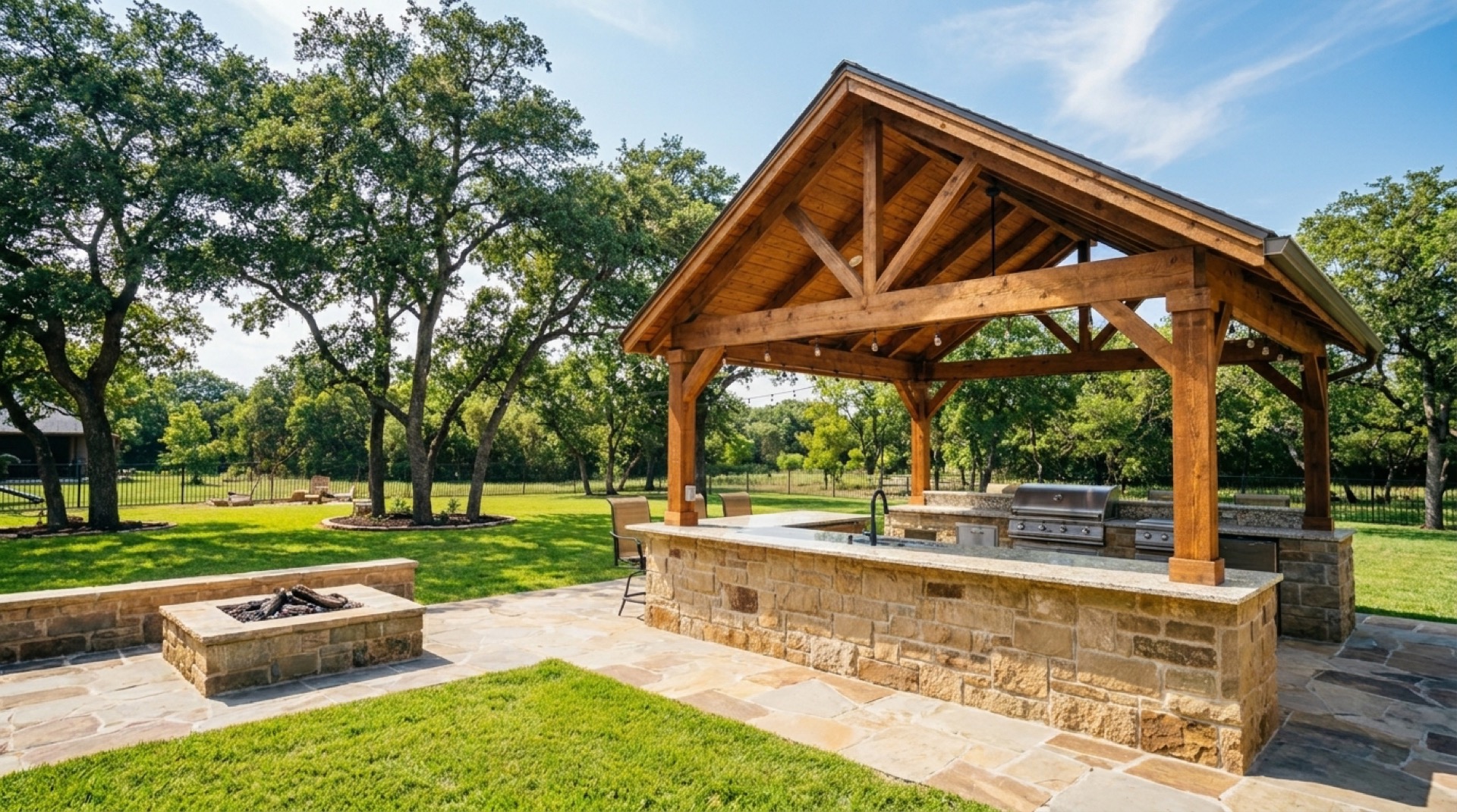 Custom cedar pavilion and stone outdoor kitchen in a DFW backyard by Legado Outdoor Living